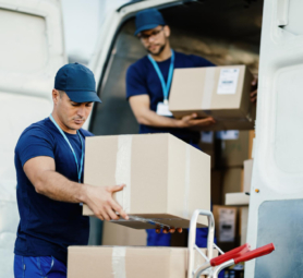 young-courier-his-colleague-unloading-cardboard-boxes-from-delivery-van